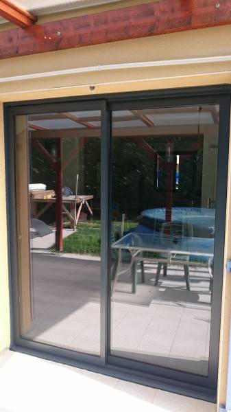 Pose d'une baie coulissante à Masieux à la place d'une porte fenêtre bois